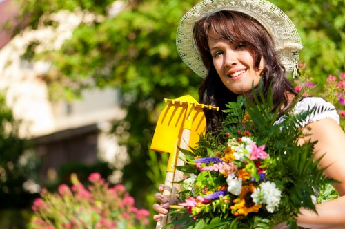 Professional lawn mowing team working in a city-centre garden